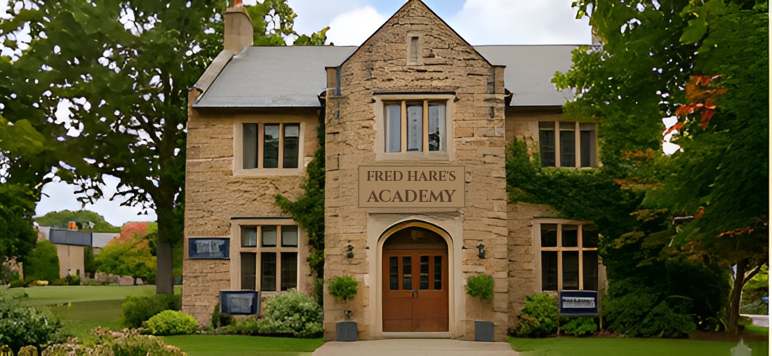 A stone building with a sign reading Fred Hare's Academy