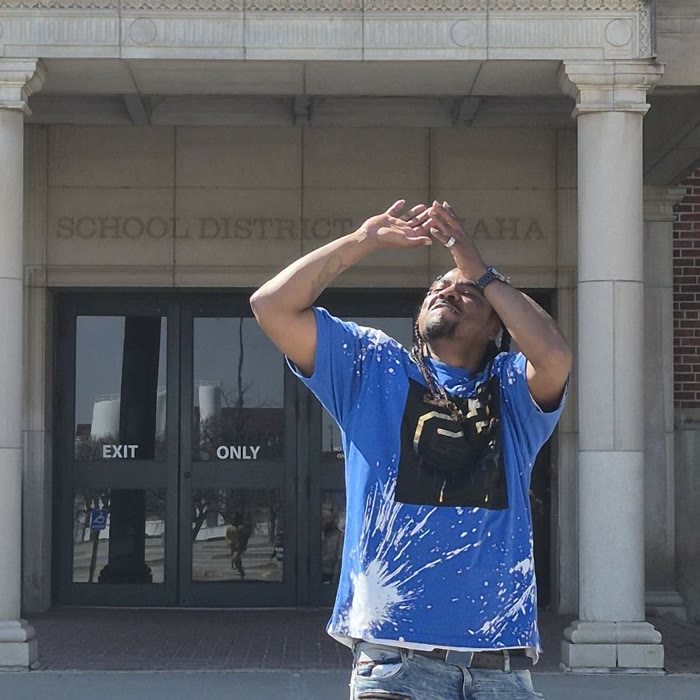 Freddie Lee Hare Jr. in the same shooting pose outside the School District of Omaha building